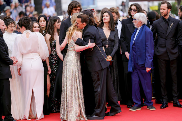 Pauline Pollmann and Johnny Depp hug on the red carpet.