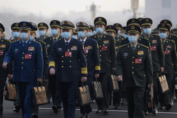 Military delegates arrive to attend the opening session of China’s National People’s Congress on Sunday.