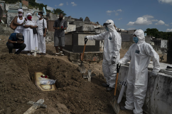 Taina dos Santos, third from left, attends the burial of her mother Ana Maria, a 56-year-old nursing assistant who died from the new coronavirus, in Rio de Janeiro, Brazil.