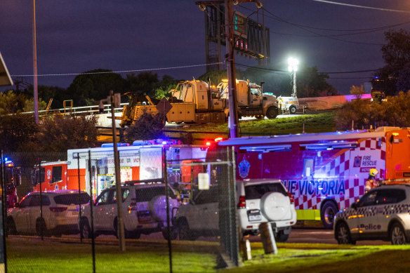 Emergency services at the scene after a truck carrying hazardous chemicals crashed over an embankment on the Western Ring Road.