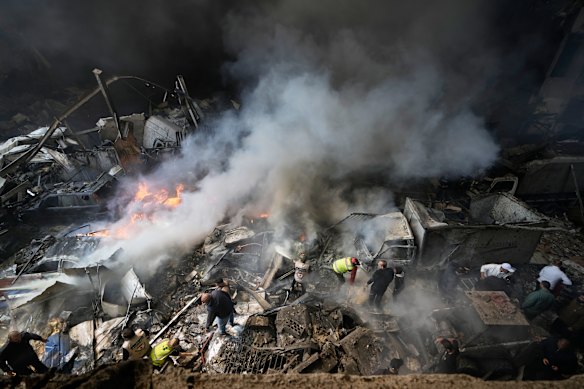 First responders search an apartment building hit by an Israeli airstrike in Beirut.