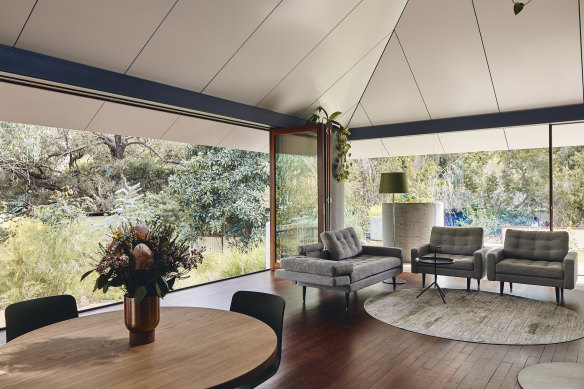 Partition walls divide the floor plan into public, semi-public and private areas under a single, tent-like roof structure.