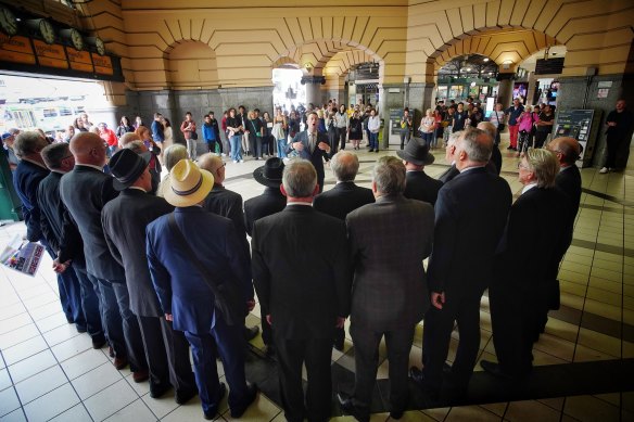 Men in Suits during a pop-up performance at Flinders Street Station on Sunday.