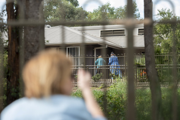 Mary Watson waves to her mother Alice Bacon, 93, who currently has coronavirus at Newmarch House. 