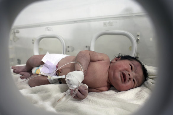A baby girl born under the rubble receives treatment inside an incubator at a hospital in Afrin, Aleppo province, Syria.