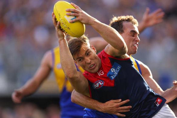 Jack Viney of the Demons is tackled by Luke Edwards of the Eagles.