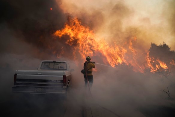 Firefighter Raymond Vasquez battles the Silverado Fire Monday, Oct. 26, 2020, in Irvine, California