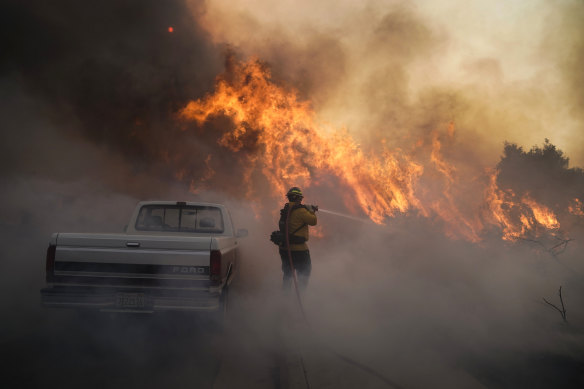 Firefighter Raymond Vasquez battles the Silverado Fire Monday, Oct. 26, 2020, in Irvine, California