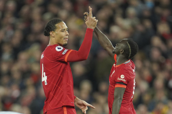 Sadio Mane (right) celebrates with his teammate Virgil van Dijk after scoring Liverpool’s third goal.