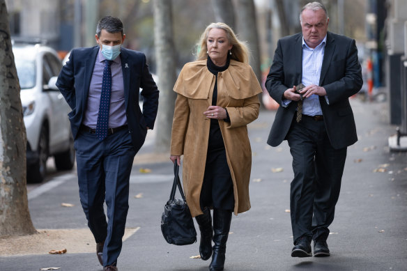 Wayne Gatt, secretary of the Police Association of Victoria, Carmel Arthur, the widow of Rodney Miller, and Peter Silk, the brother of Gary Silk, arrive at the Supreme Court.