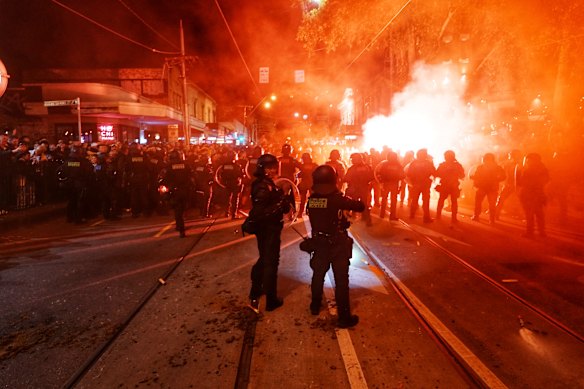 Fans set off flares in Swan Street, Richmond, ahead of the A-League grand final at AAMI Park on Saturday night.