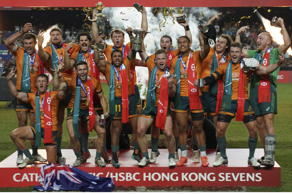 Australian players celebrate after winning the Hong Kong Sevens rugby tournament against Fiji.