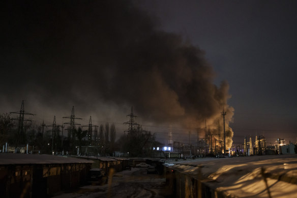 moke billows from a power infrastructure following a Russian drone attack in Kyiv in mid-December.