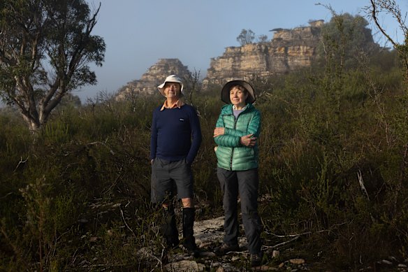 Conservationists Keith Muir and Madi Maclean standing at site 2, where the glamping cabins would be built under the stone pagodas.