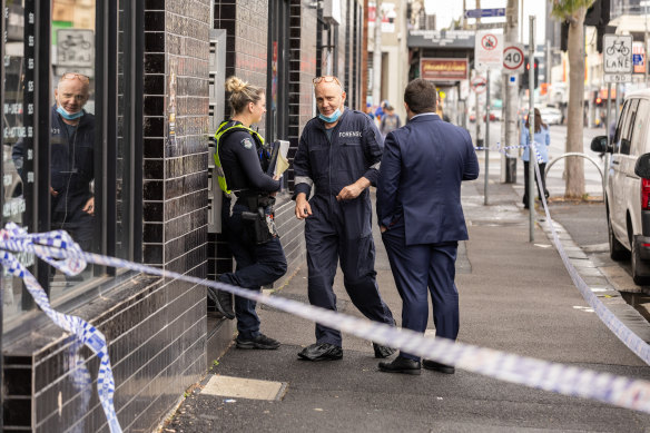 Homicide squad detectives at the scene of the stabbing. 