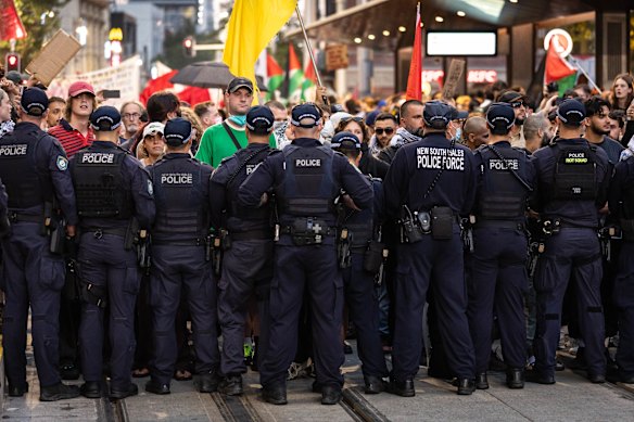Palestine Action Group members and supporters hold a protest and eventually clash with police near Town Hall during the Israeli president’s visit to Sydney.