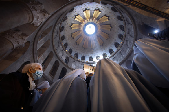 A masked woman attends Easter Sunday Mass led by Latin Patriarch of Jerusalem Pierbattista Pizzaballa at the Church of the Holy Sepulchre in Jerusalem. 