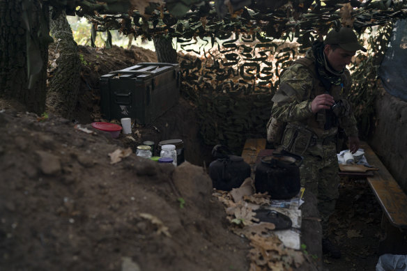 A Ukrainian serviceman checks the trenches dug by Russian soldiers in a retaken area in Kherson region.