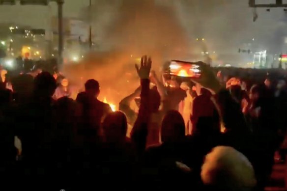Footage circulating on social media shows protesters in Tehran dancing and cheering around a bonfire.