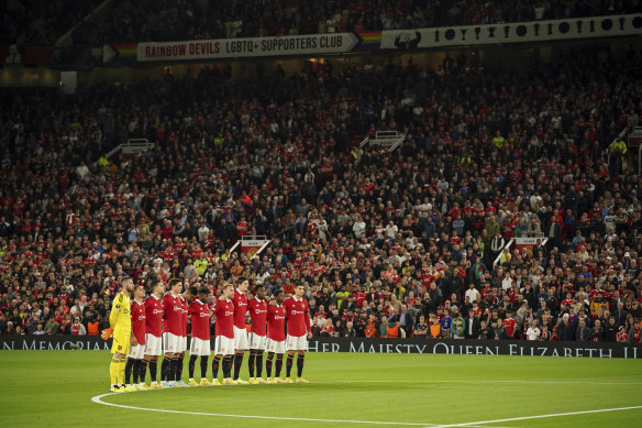 Manchester United players observe a minute's silence at Old Trafford before their Europa League clash.