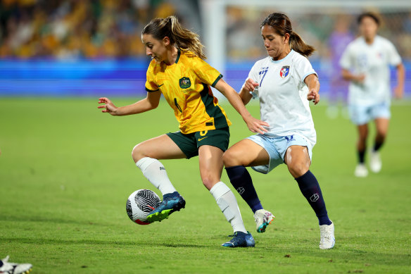 Clare Wheeler of the Matildas controls the ball away from Ting Chi of Chinese Taipei.
