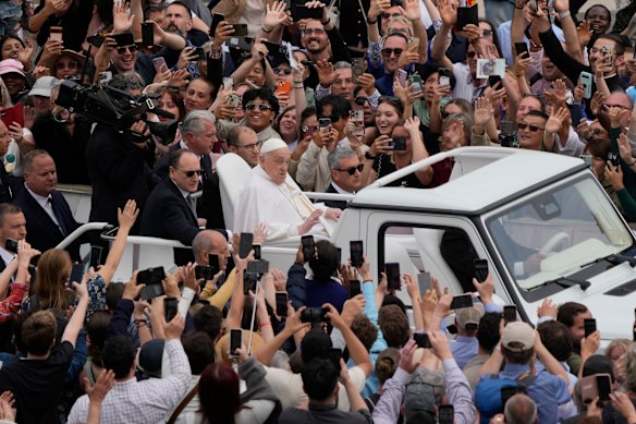 Pope Francis tours St Peter’s Square in his popemobile.