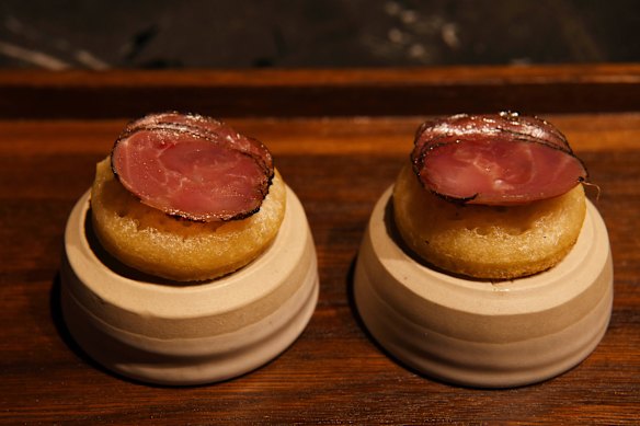 Sourdough crumpets topped with roasted macadamia butter and duck ham.