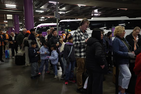 Passengers wait to board replacement coaches at Melbourne’s Southern Cross Station on Thursday morning.