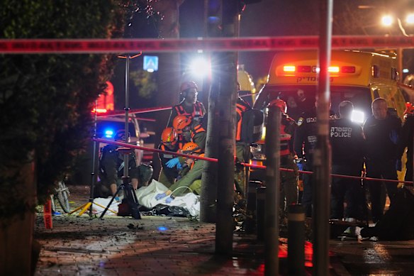 Israeli first responders remove the body of a person killed in an Iranian missile strike in Tel Aviv early on Saturday.