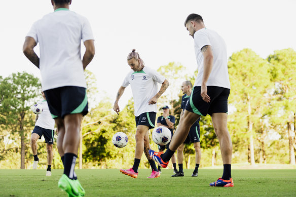 Harry Souttar and Jackson Irvine warm up on Tuesday.