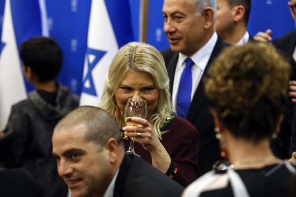 Israeli Prime Minister Benjamin Netanyahu, background, and his wife Sara, centre, toast the new speaker of the knesset, Amir Ohana, at the Knesset.
