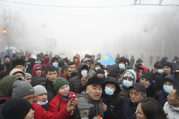 Demonstrators pictured on the streets of Almaty, where government buildings and broadcast offices have been raided and smashed. 