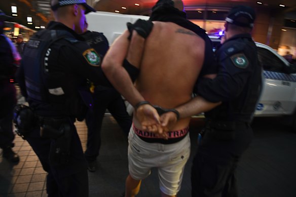 A demonstrator at Town Hall is taken away by police.