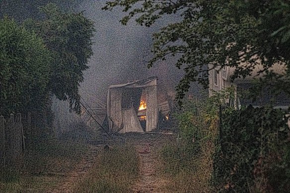 A burning barn next to a farmhouse near Le Porge, in France.