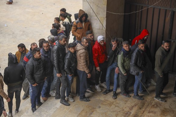 Defectors line up to register with Syrian insurgents in Aleppo on Thursday. Rebels have called on government soldiers and security agencies to defect and receive “protection cards”.