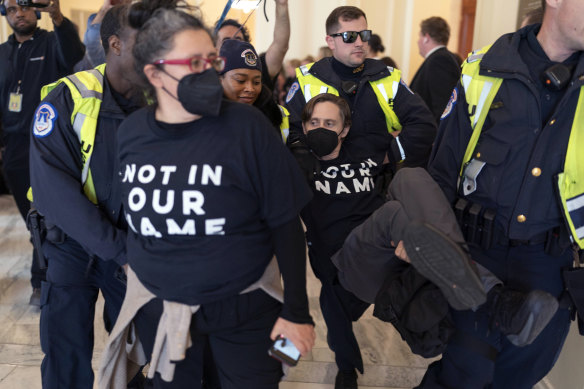 US Capitol Police officers detain a demonstrator protesting inside the Cannon House Office Building on Capitol Hill in Washington.