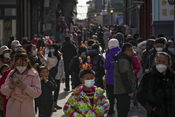 People in a pedestrian shopping street at Qianmen, Beijing, on the first day of the Lunar New Year.