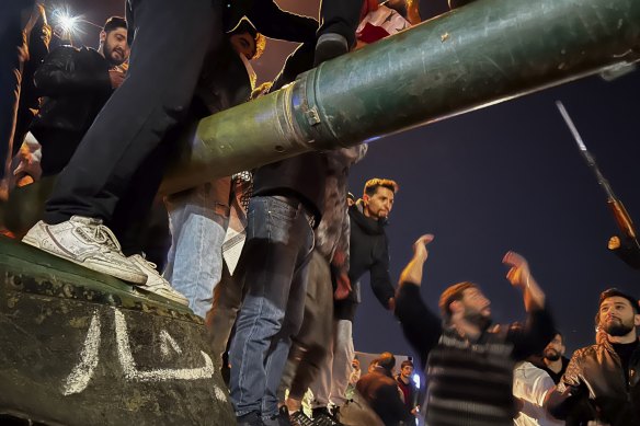 Opposition fighters arrive to cheers in the Syrian capital on Sunday.