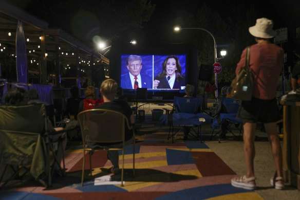 People watch the presidential debate in Jarvis Square, north of Chicago.