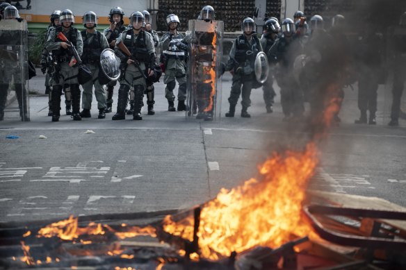 Riot police square off with protesters in Hong Kong on Saturday.