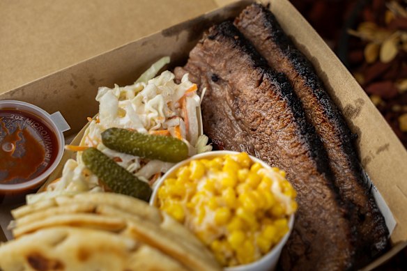 The brisket box with slaw, cheesy corn and house-made BBQ sauce on the side.