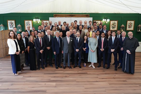 King Charles III poses with attendees during a meeting for leaders from the artificial intelligence sector.