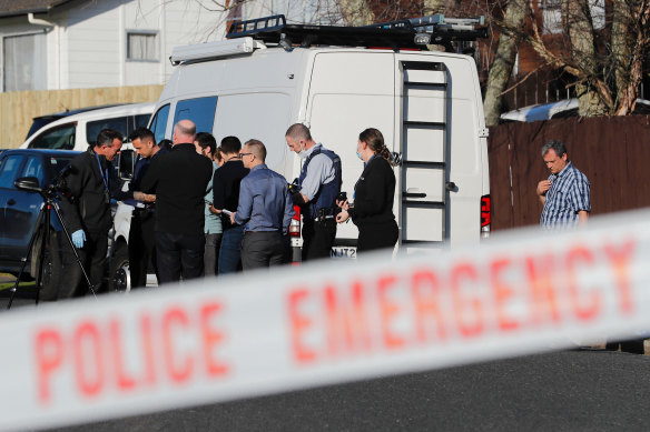 New Zealand police investigators work at a scene in Auckland after bodies were discovered in suitcases bought at storage place auction. 