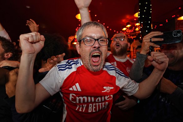An Arsenal fan celebrates at a pub in London.
