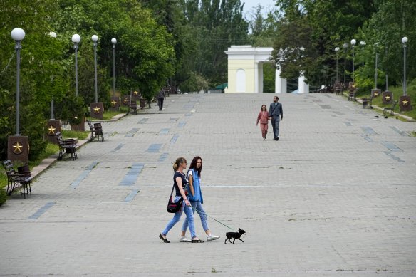 Local residents walk in Kherson in May.