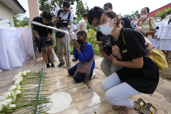 Relatives mourn during a ceremony for those killed in the attack