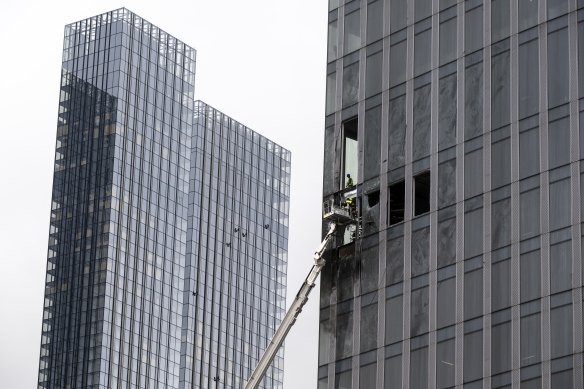 Workers clean part of a damaged skyscraper in Moscow’s business district after a reported drone attack last month.
