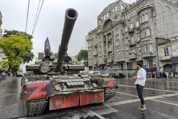 Servicemen sit in a tank with a flag of the Wagner Group military company and writing reading “Siberia”, as they guard an area at the HQ of the Southern Military District in a street in Rostov-on-Don, Russia on Saturday.