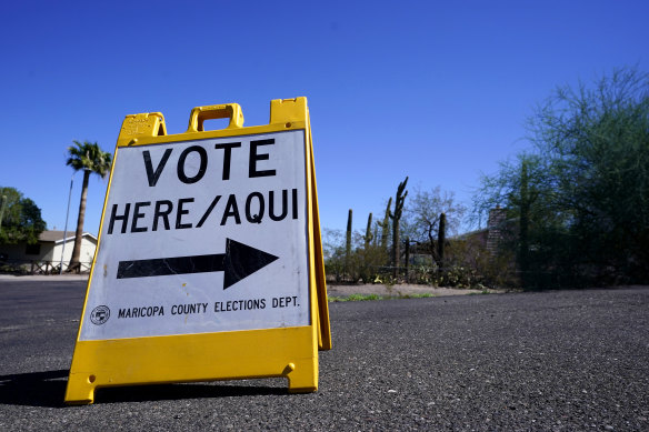A sign marks the entrance to a voting precinct on the first day of early voting in the general election in Phoenix. 