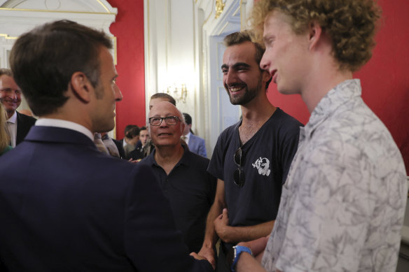French President Emmanuel Macron meets Henri, second right, the 24-year-old ‘backpack hero’, who suffered minor stab wounds as he tried to intercept the suspect.